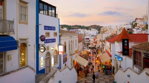 a group of people walking down a city street at Son of a Beach Hostel in Albufeira
