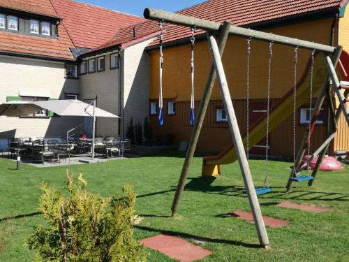 an empty swing set in the yard of a house at Hotel Landgasthaus Neues Bild, Eggerstanden in Appenzell