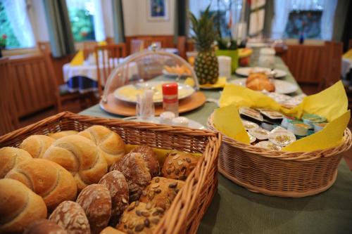 two baskets of bread and pastries on a table at Hotel Pension Schweitzer in Silandro