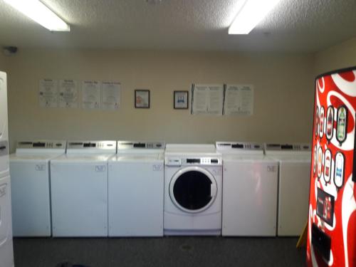 a laundry room with white washing machines and a washer at InTown Suites Extended Stay San Antonio TX - Nacogdoches Road in San Antonio