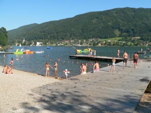 a group of people on a dock at a lake at Ferienwohnungen Vidoni in Bodensdorf