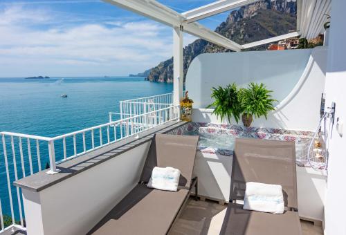 a balcony with a view of the ocean on a cruise ship at Villa Pietra Santa in Positano