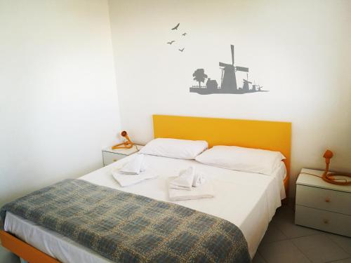 A bed or beds in a room at SanvitoTour - Appartamenti Il Mulino