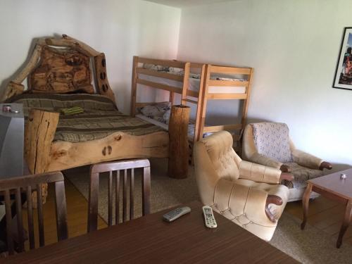 a bedroom with a bed and a chair and a table at Kitka Hostel - Guest House in Tetovo