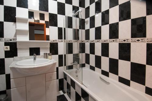 un bagno con lavandino e vasca da bagno di Cozy Beach Front with Rooftop a Vila do Conde