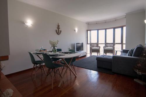 a living room with a table and a couch at Cozy Beach Front with Rooftop in Vila do Conde
