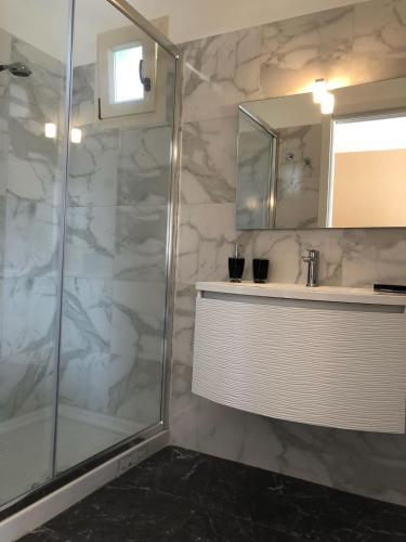 a bathroom with a shower and a sink and a mirror at B&B Villa Jonica in Gallipoli