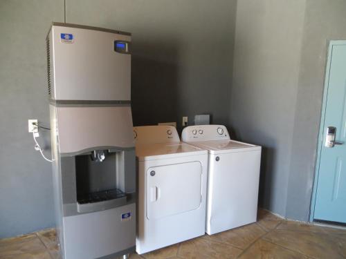a kitchen with a refrigerator and a washer and dryer at Hotel Blue - Woodlands in Spring