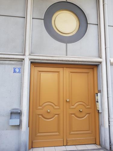a yellow door in a building with a circle above it at Studio With Swimming Pool 80 meters near the beach in Nice
