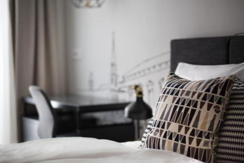 a bedroom with a bed with a pillow and a desk at Classy Design Accommodation in Zadar