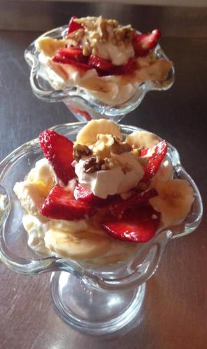 two glass dishes of dessert with strawberries and whipped cream at Platoni Elite Villas in Ialyssos
