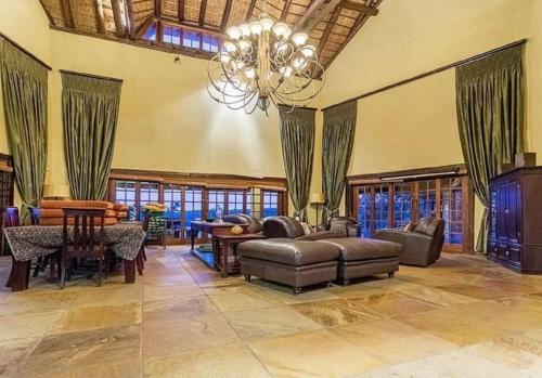 a large living room with a couch and a table at Tholo Private Game Lodge in Bela-Bela