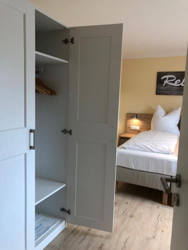 a bedroom with a bed and a white closet at Hotel Select Suites & Aparts in Mönchengladbach