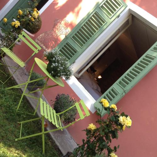 an overhead view of a house with green shutters and flowers at Il Giardino Segreto Arona, Charming Apartments in Arona