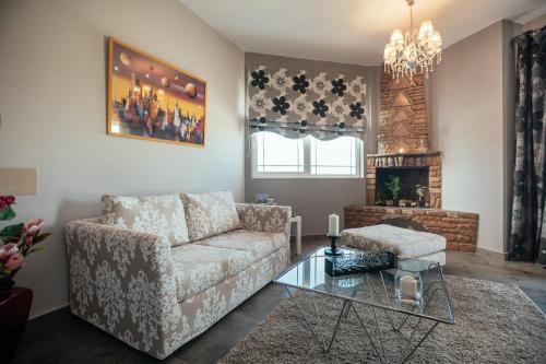 a living room with a couch and a fireplace at Private Place Nafplio Exostis in Ária