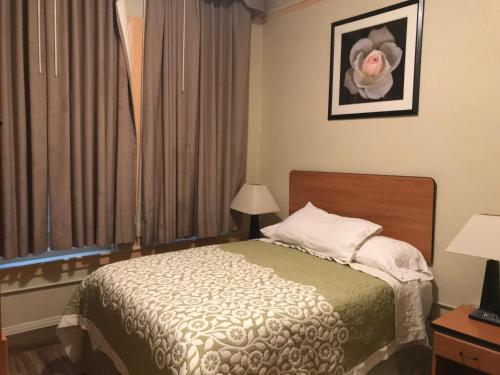 a hotel room with a bed and a window at Boston Hotel in San Francisco