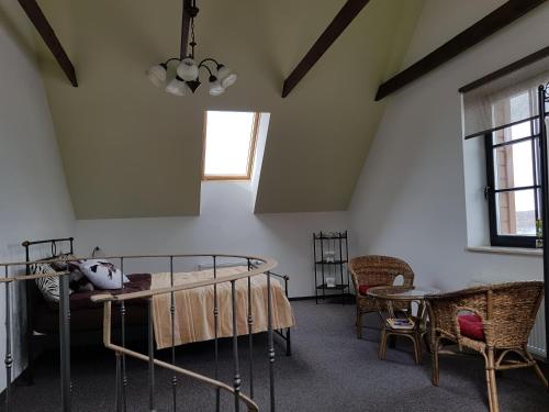 a bedroom with a bed and a table and chairs at Villa Traku Terasa in Trakai