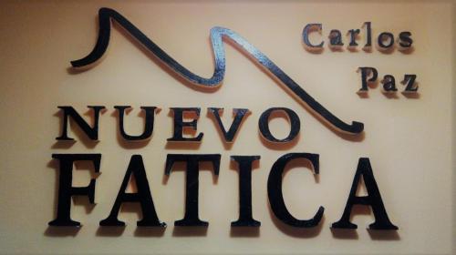a sign for a nivevo faja sign on a wall at Hotel Nuevo Fatica in Villa Carlos Paz