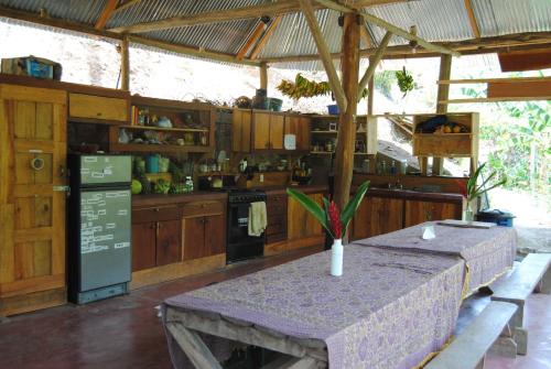 a kitchen with a table and a counter top at Ch'i Bocól Community Hostel in Lanquín