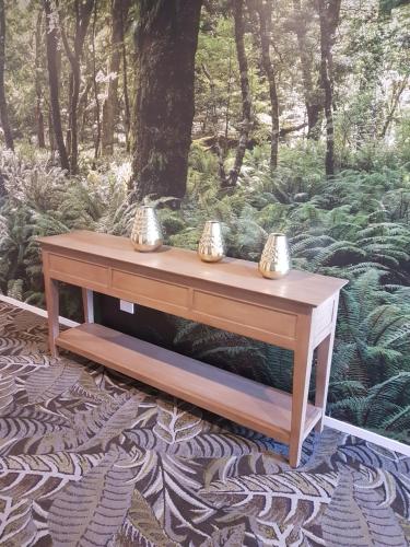 a wooden table sitting on top of a rug at Wyndham Garden Remarkables Park Queenstown in Queenstown