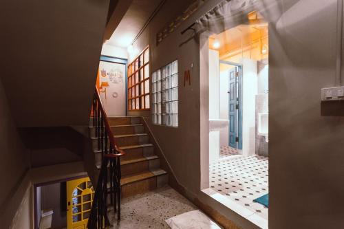a hallway of a house with stairs and a bathroom at Stash in Bangkok
