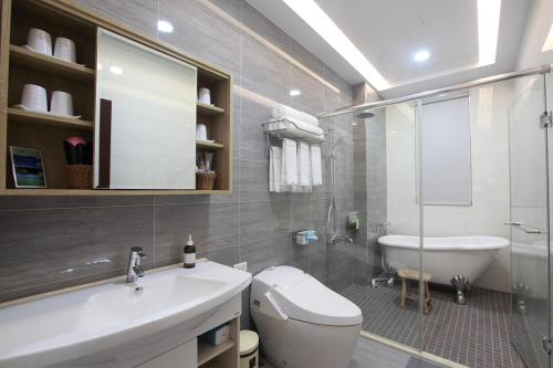 a bathroom with a sink and a toilet and a tub at Gancheng 35 in Jian