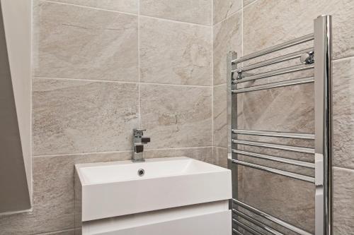 a bathroom with a white sink and a shower at Paddock Drive in Winchester