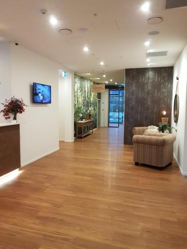 an office lobby with a couch and a wall at Wyndham Garden Remarkables Park Queenstown in Queenstown