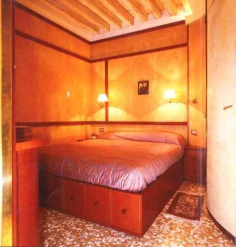 a bedroom with a bed with a wooden frame at CaFelice in Venice