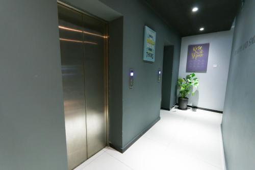 a hallway with a elevator in a building at Hotel 99 Sri Petaling (Bukit Jalil) in Kuala Lumpur