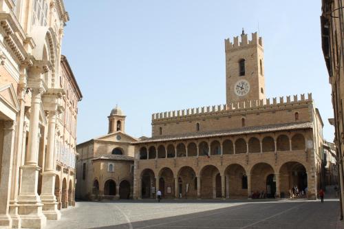a large building with a clock tower in a city at La Neviera Nel Pozzo in Offida