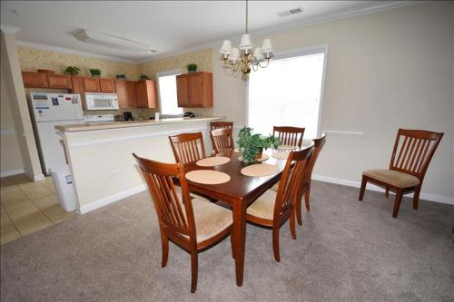 a dining room with a table and chairs in a kitchen at 1011 Willow Bend Condo in North Myrtle Beach