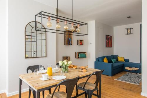a living room with a table and a blue couch at Urban Suites Brussels Royal in Brussels