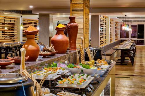 a buffet in a restaurant with many different foods at Sterling Wayanad in Sultan Bathery