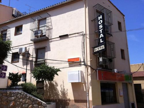 a building with a sign for a hotel at Hostal L'Escaleta in Oropesa del Mar