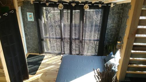 a room with a window with a couch in front at Guest House Serena in Chornomorsk