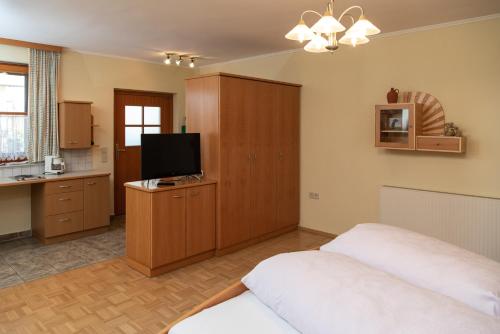 a bedroom with two beds and a flat screen tv at Bauernhof Flucher-Plaschg in Straden