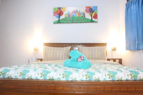 a bed with a stuffed animal on top of it at JS Guest House in Seminyak