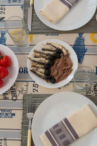 a table with plates of food on a table at Hrast in Krk