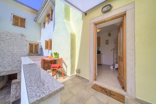 an open door to a patio with a table at Hrast in Krk