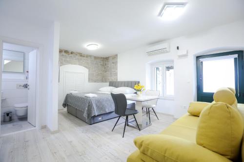 a bedroom and a living room with a bed and a couch at Villa Kate in Split