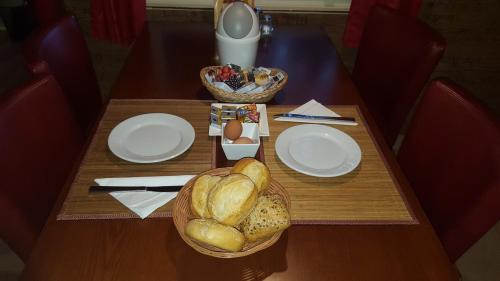 a table with plates and baskets of bread and eggs at Camping-Aller-Leine-Tal in Engehausen