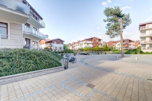 a bike parked in a courtyard next to a building at Dom & House - Apartment Neptun Park Premium in Jelitkowo