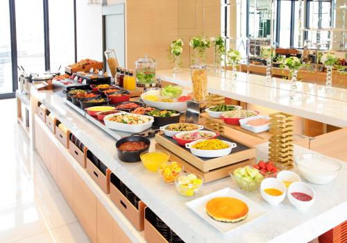 a buffet line with many different types of food at Candeo Hotels Kobe Tor Road in Kobe