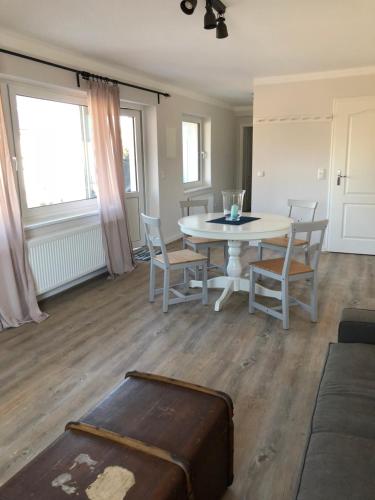 a living room with a table and chairs at Hotel & Ferienunterkünfte Hus Seeblick in Fehmarn