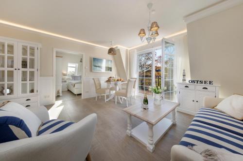 a living room with a couch and a table at Villa Strandblick in Zingst