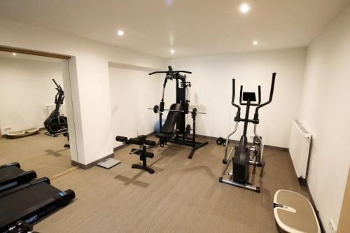 a gym with several exercise bikes in a room at Maison d'hôtes & SPA La Scierie in Salins-les-Bains