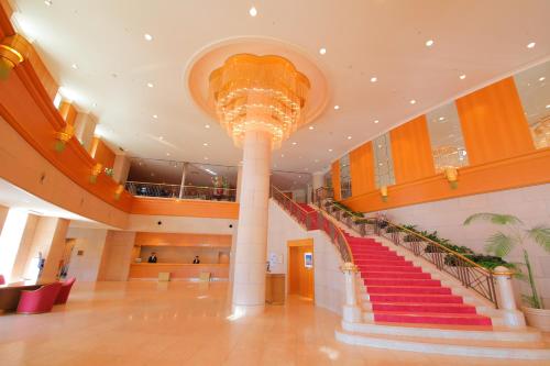 a large lobby with a staircase in a building at Surfeel Hotel Wakkanai in Wakkanai