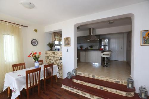 a kitchen and a dining room with a table and chairs at Villa Vista in Ermoupoli