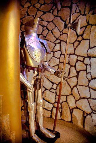 a robot standing in front of a stone wall at Zamek Pod Brzozami, Wynajem Pokoi in Krynica Zdrój